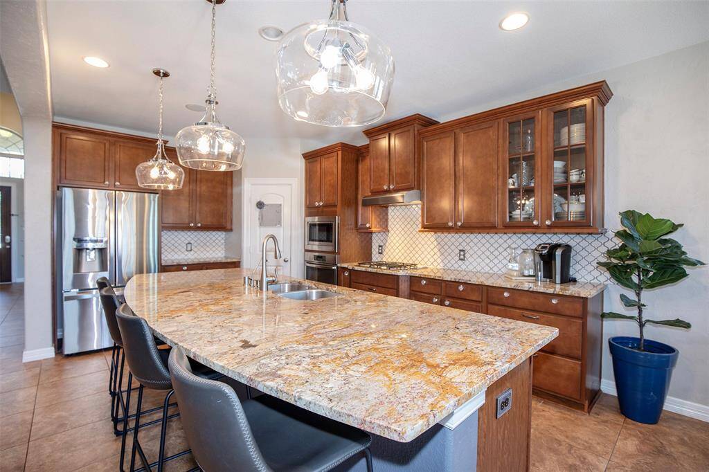 This beautifully designed kitchen combines elegance and functionality, featuring stunning granite countertops that provide ample workspace and a touch of luxury.