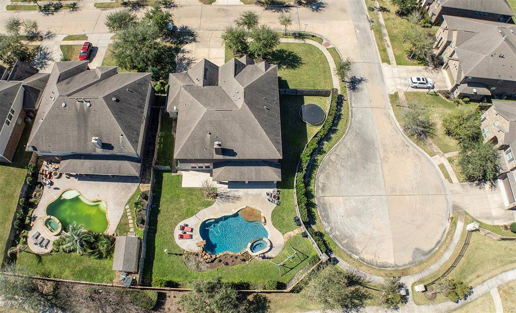 Fabulous aerial view shows the pristine pool and wonderful yard space.