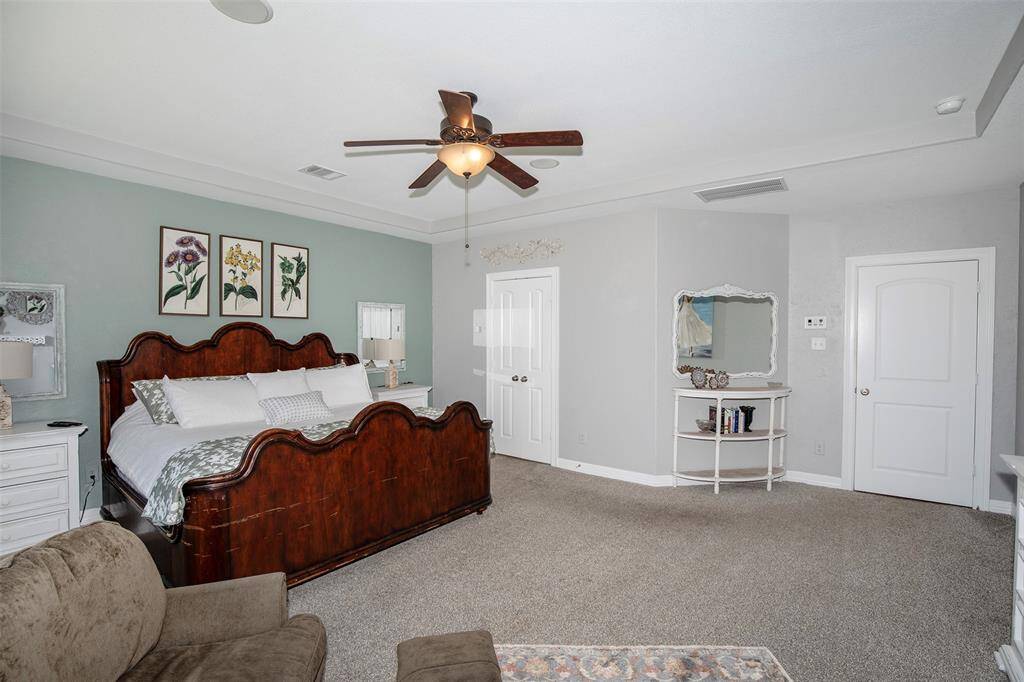 The primary bedroom is conveniently located on the first floor, featuring a luxurious en suite and a generous walk-in closet.
