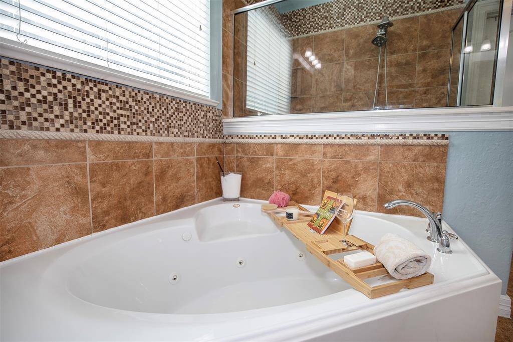 A large jetted bathtub serves as the focal point, perfect for unwinding after a long day.
