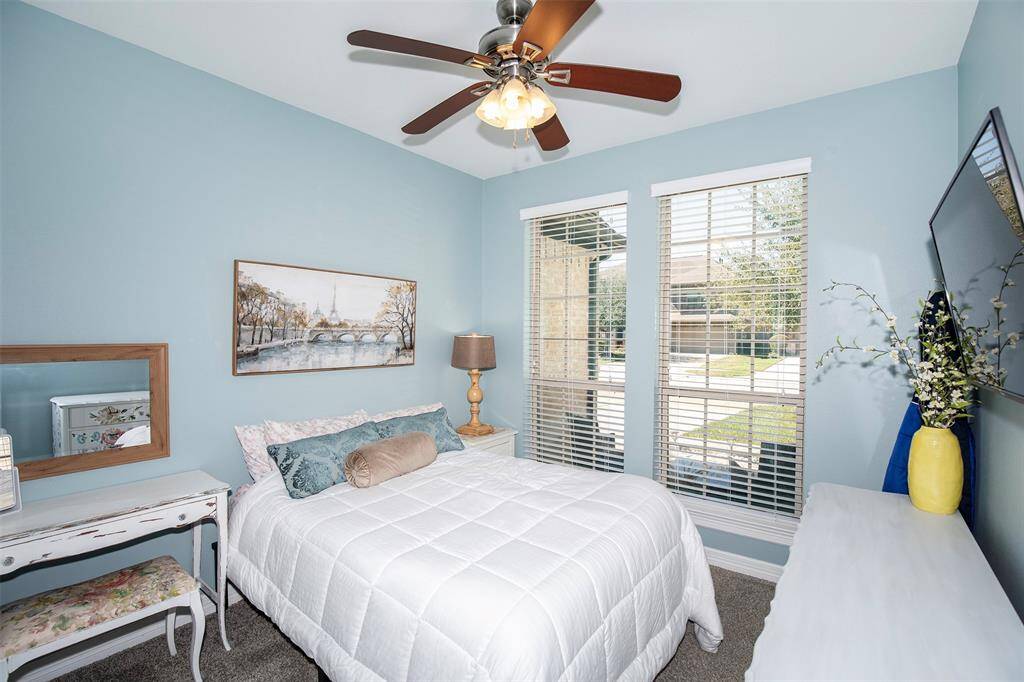 A secondary bedroom on the main level provides flexibility for guests or multi-generational living.
