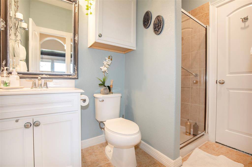 The guest bathroom is accessible from the bedroom as well as a hallway, making it convenient for guests.