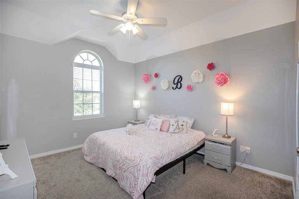 This secondary bedroom offers plenty of space and natural light, creating a warm and inviting atmosphere. A generous closet provides ample storage, while neutral tones make it easy to personalize.