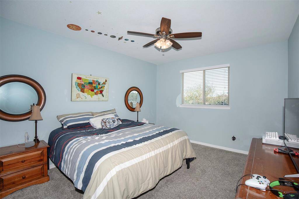 With its comfortable layout and soft natural light, this secondary bedroom is perfect for guests, family members, or even a home office. A ceiling fan adds comfort, and the room’s quiet location ensures peaceful rest.