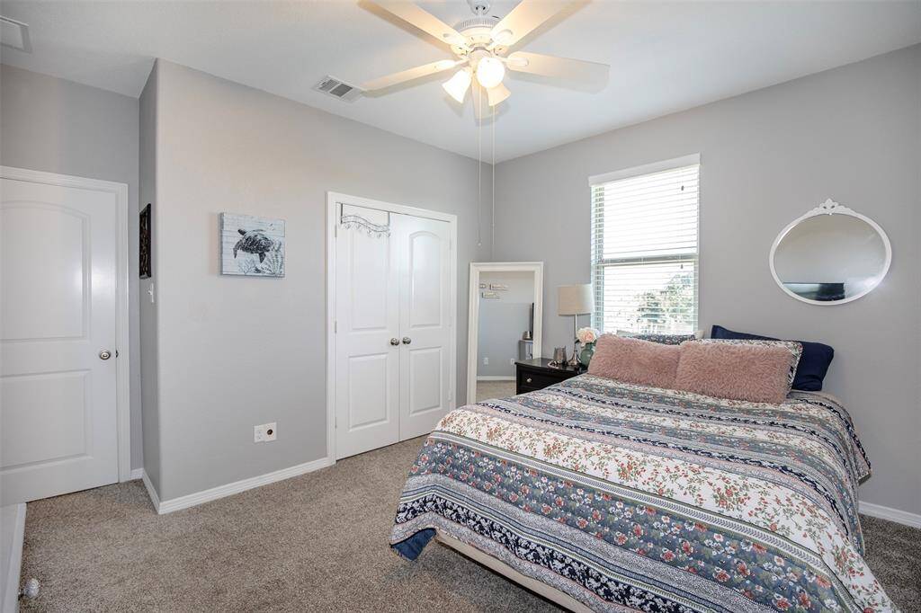 This well-sized secondary bedroom features a large window that brightens the space, along with a roomy closet for organization. Its versatile design makes it ideal for a bedroom, study, or playroom.
