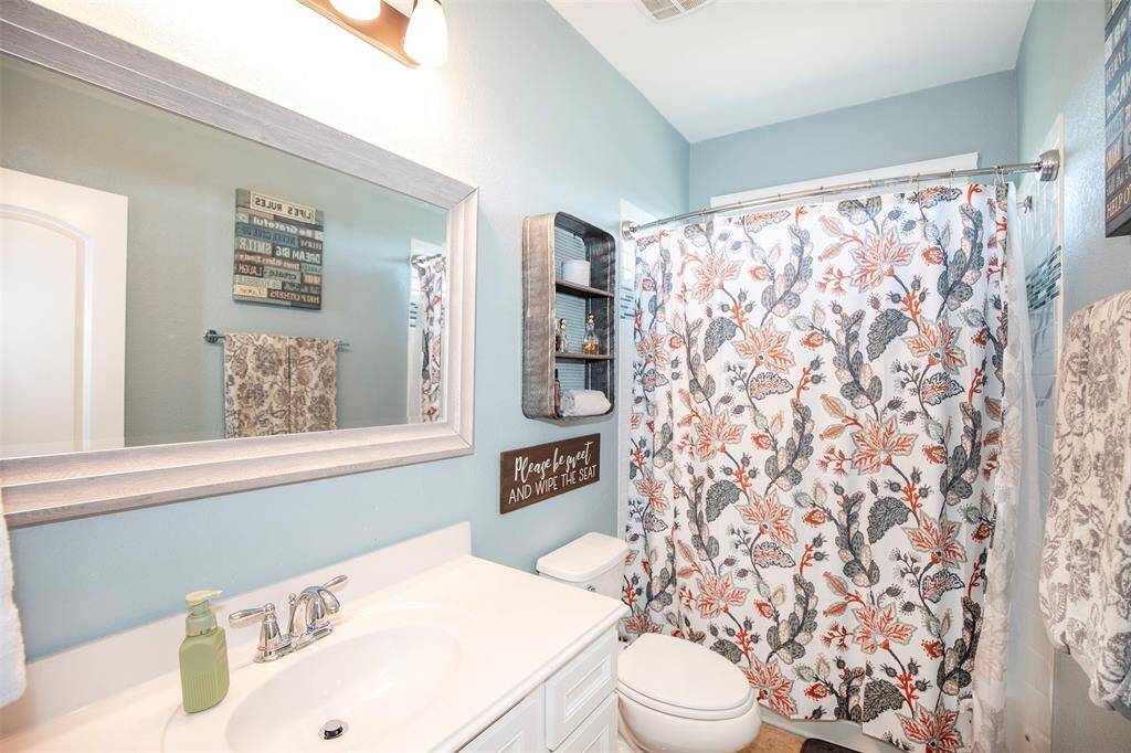 This bathroom is located near the entertainment area.