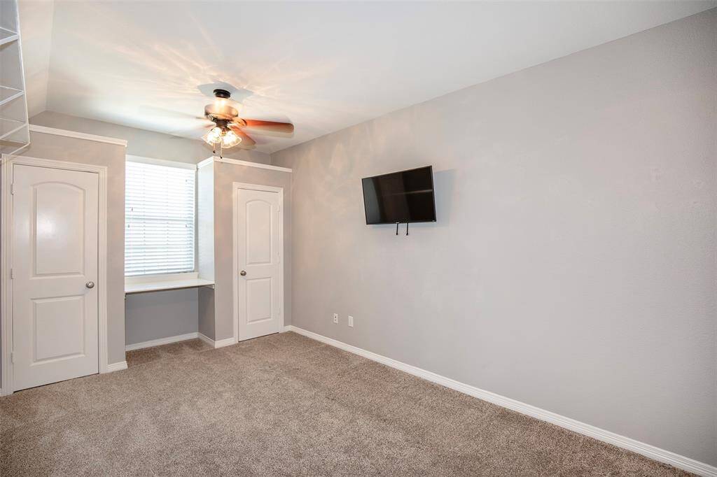 Tucked away for added privacy, this secondary bedroom provides a quiet retreat. Plush carpeting and a soft color palette create a cozy feel.