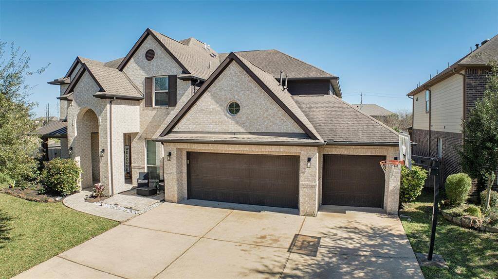 The home boasts a three car garage and a seating area near the front door.