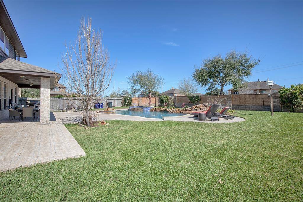 The huge backyard with wonderful entertaining space is the perfect place for a cookout with family or friends.