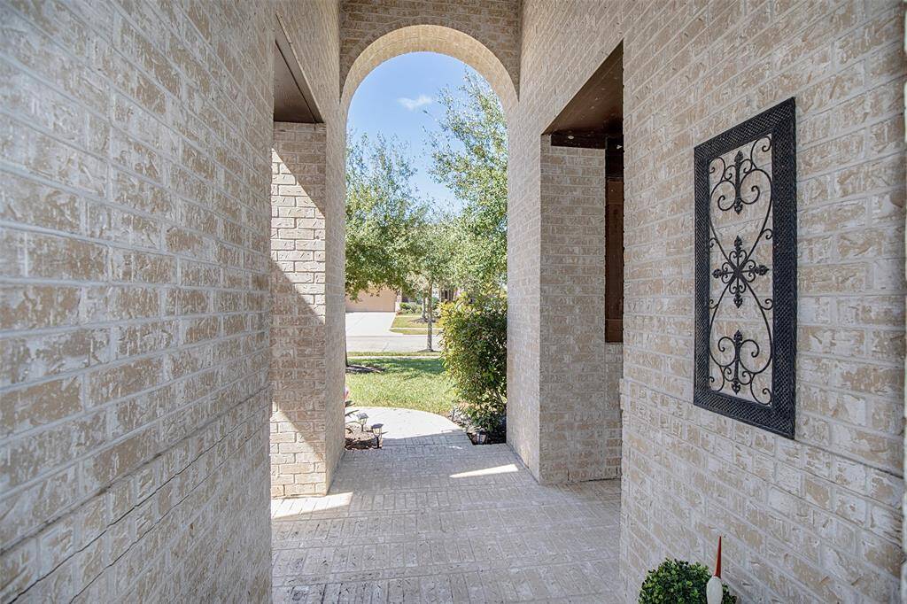 Entry to the home is through the grand arched entrance.