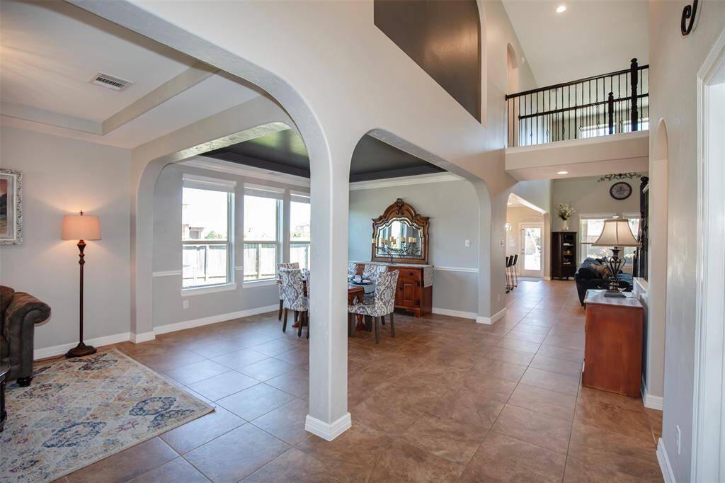 As you step into this beautiful home, you're welcomed by a soaring two-story entryway that creates a grand first impression.