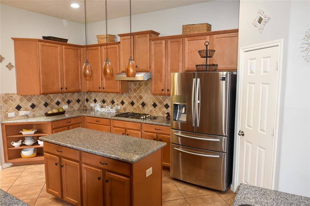 The heart of the home features a well-appointed kitchen with sleek countertops, ample cabinet space, and modern appliances.