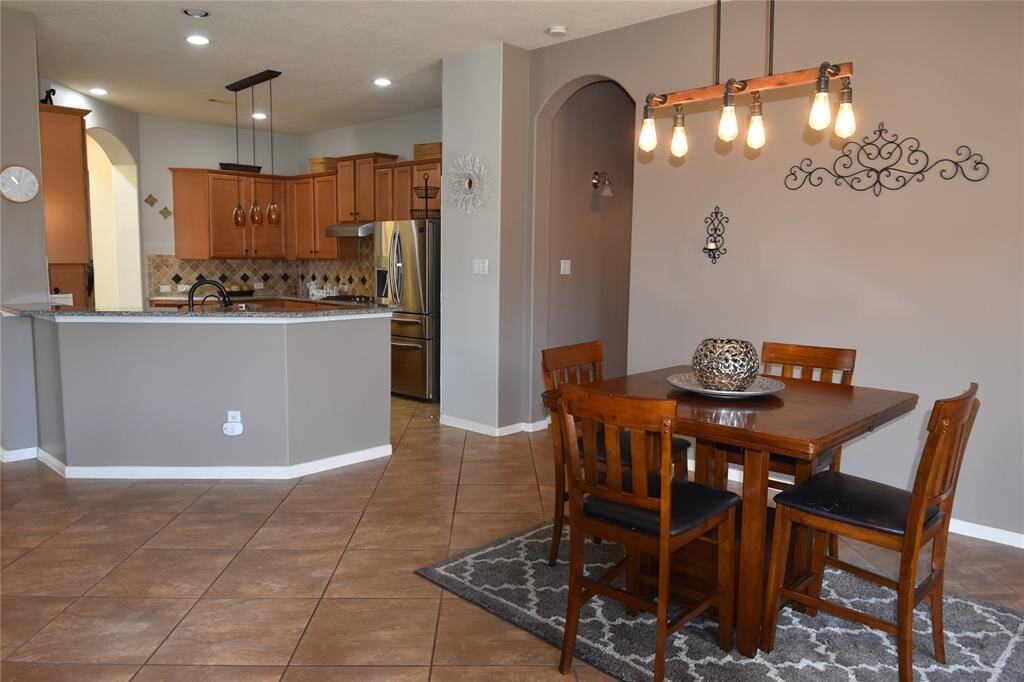 Overlooking the dining area, this open flow design makes mealtime and gatherings effortless!