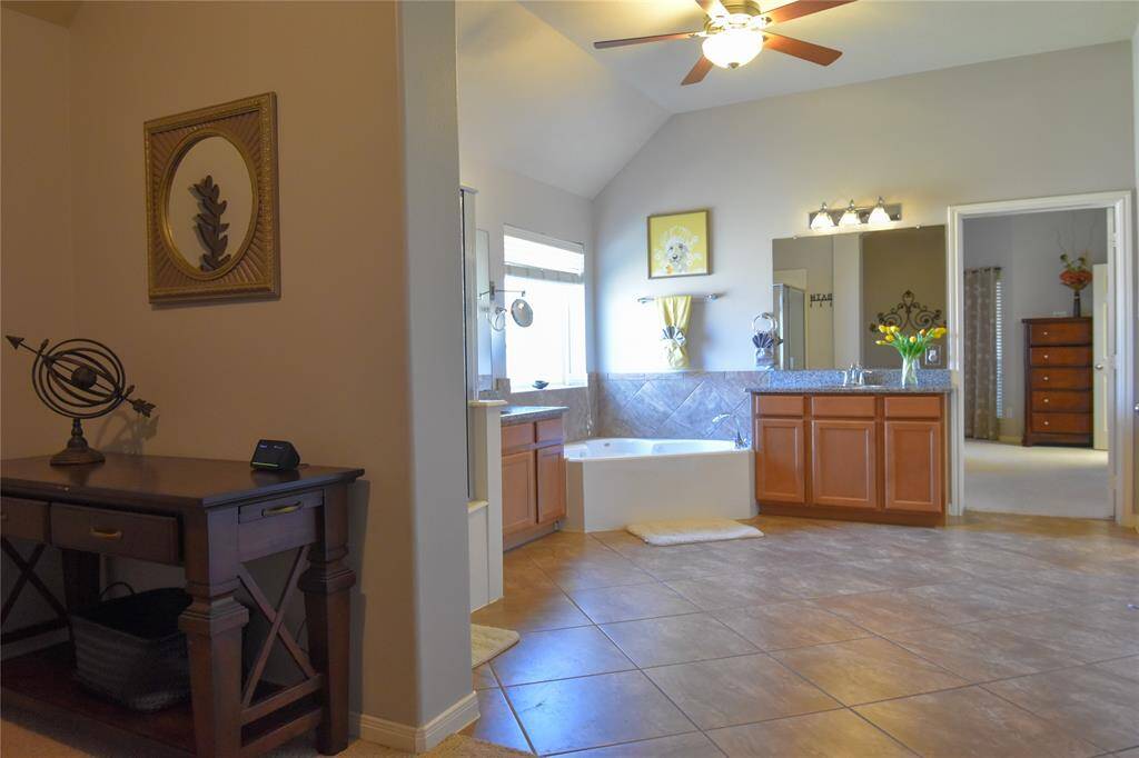 Indulge in the primary bath oasis, featuring dual vanities, a soaking tub, a separate walk-in shower, and a generous walk-in closet—your private retreat after a long day!