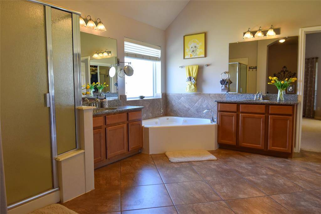 Indulge in the primary bath oasis, featuring dual vanities, a soaking tub, a separate walk-in shower, and a generous walk-in closet—your private retreat after a long day!