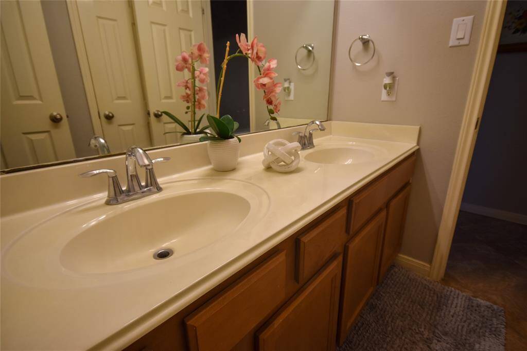 Well-maintained and stylish, the guest bath and convenient half-bath feature modern finishes and ample storage for everyday comfort.