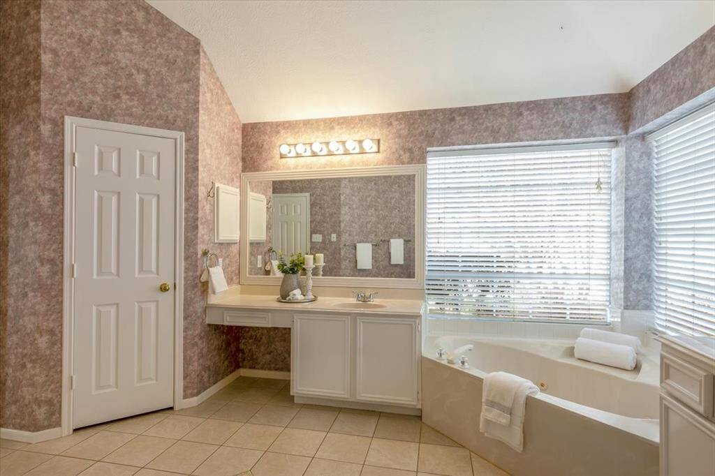 Spacious primary bath featuring dual vanities with ample counter space and a dedicated vanity area for added convenience.
