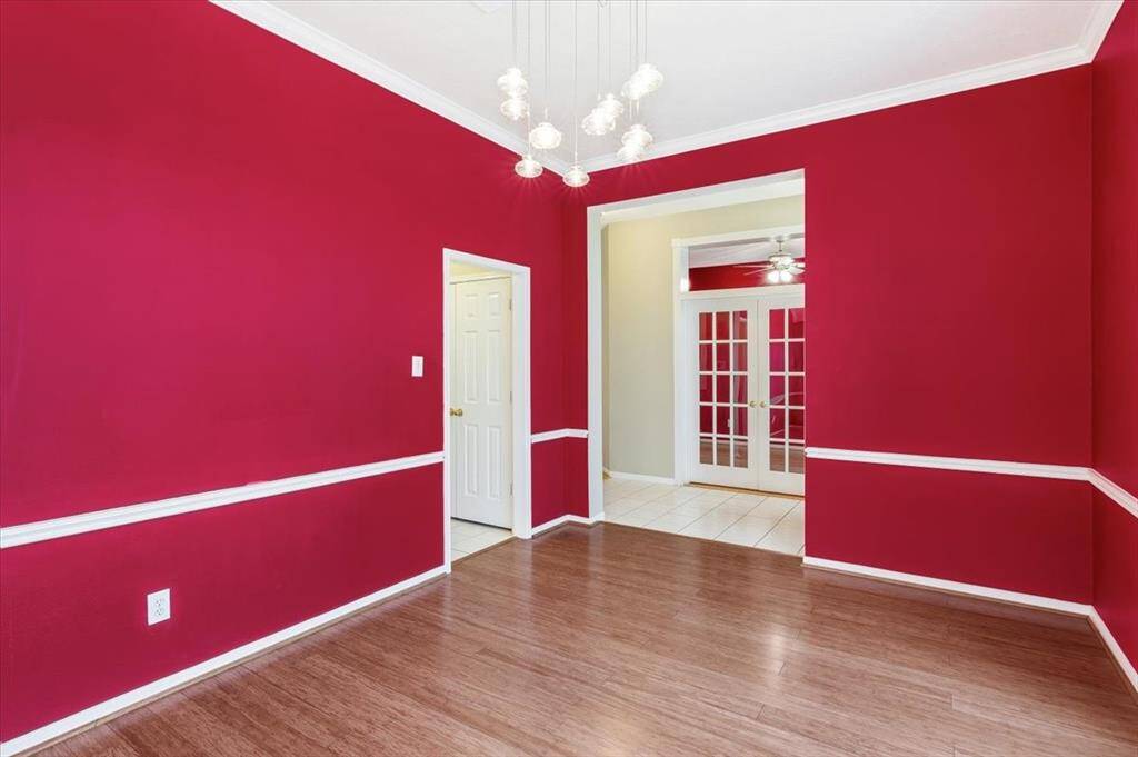 Another angle showcases the dining room’s spacious layout, with the home’s entryway to the right and a seamless connection to the kitchen on the left, creating a natural flow for entertaining and everyday living.