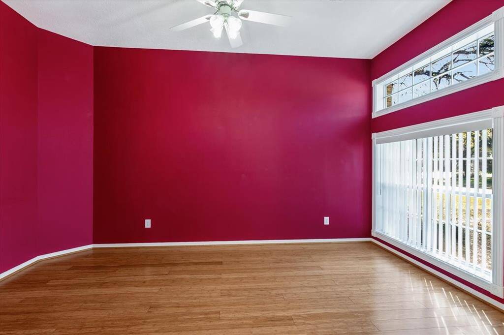 Spacious office with a flexible layout, ideal for work or a creative space. A wall of windows brings in plenty of natural light, enhancing the open and inviting feel.