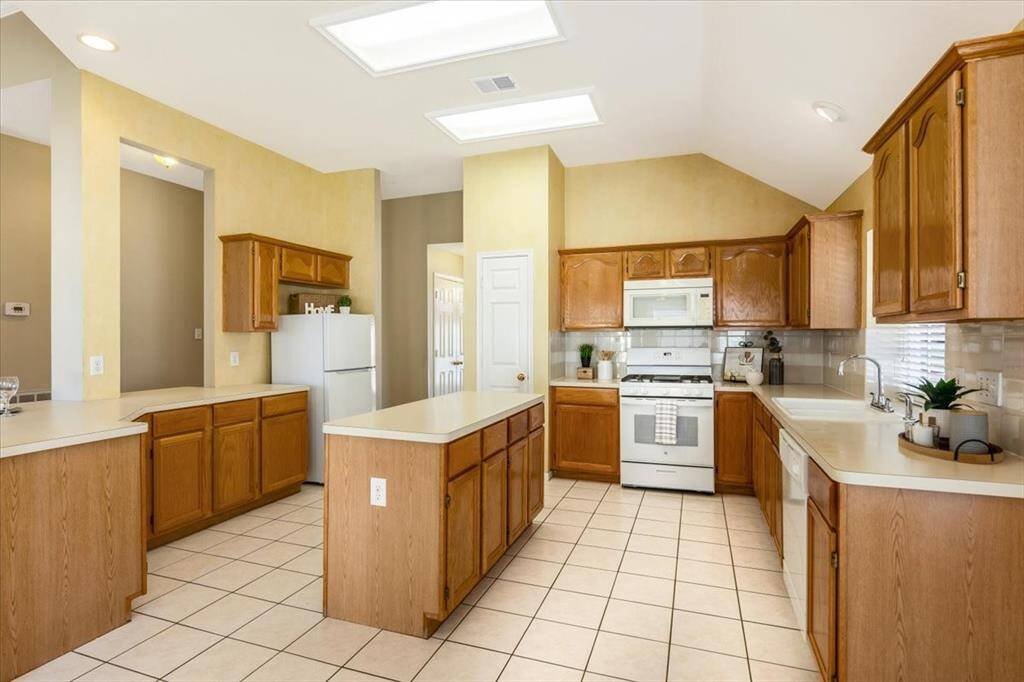 The gourmet kitchen is equipped with gas range, microwave, dishwasher and refrigerator.