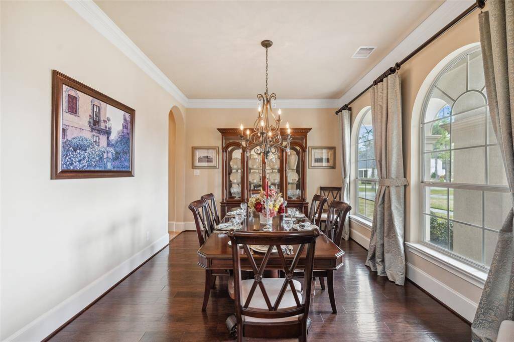 This is a large dining room that can absorb a very long table and a room for hosting many events.