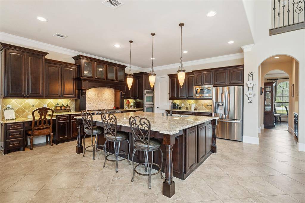 Luxurious cabinetry; gas cooktop; double ovens and an extra-large pantry for storage.  There is a butler's pantry between kitchen and dining room.