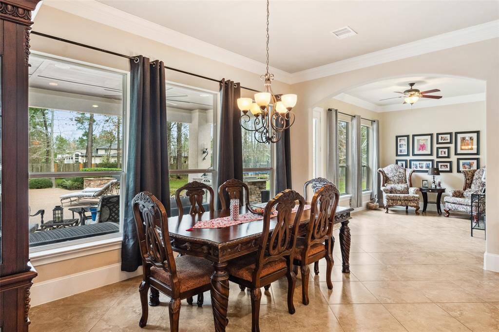 Breakfast room with a spread of windows and a view into the sitting room off of the kitchen.