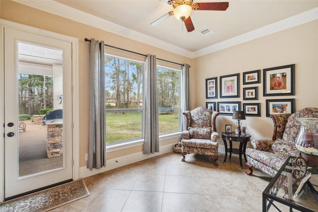 The sitting room has an ideal view of the lush landscaping.