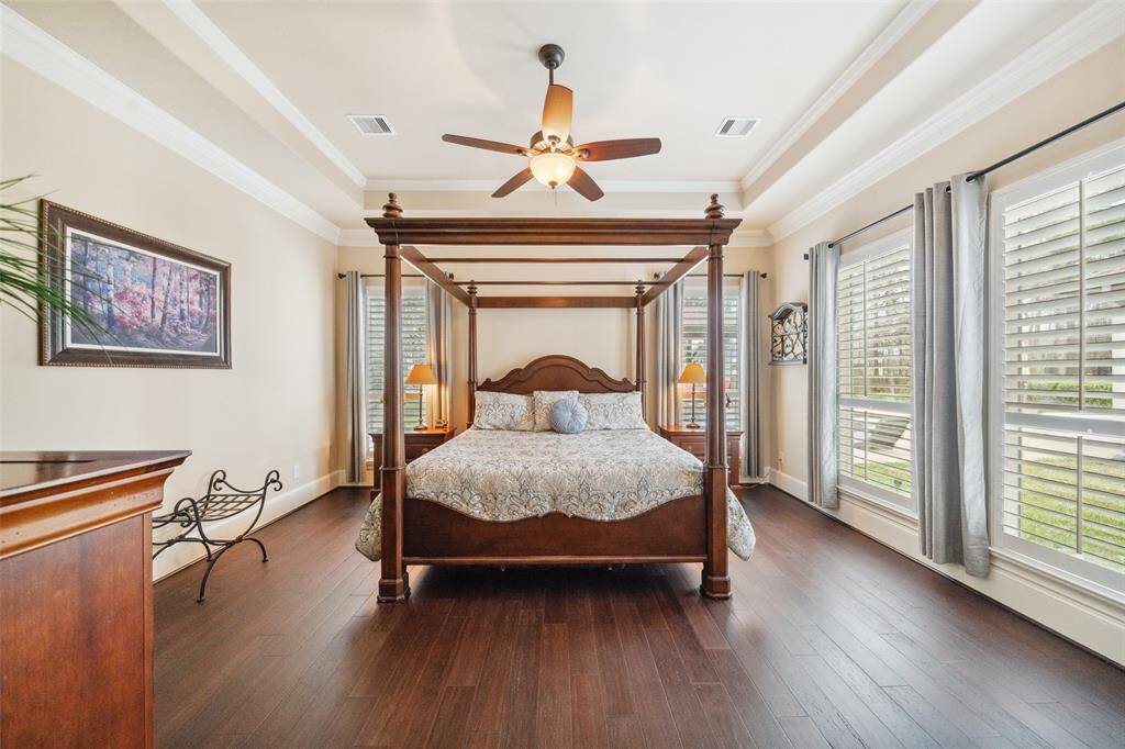 The owners' retreat shows off the design of ceiling and fabulous location to see the sprawling backyard with pool.