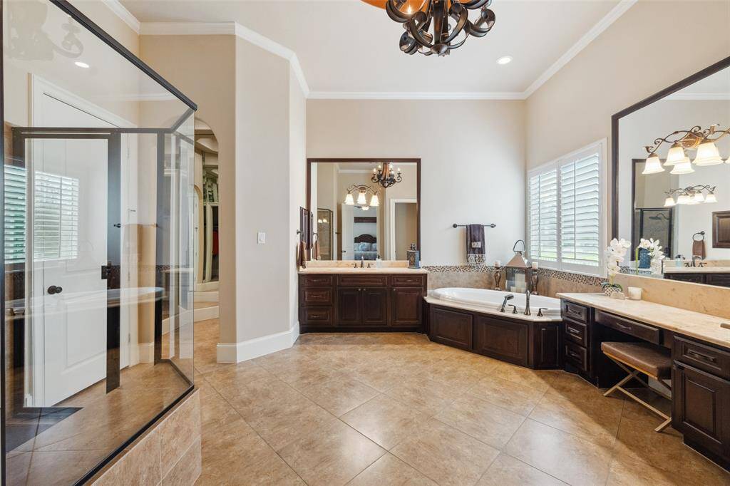 If you want a grand space, to relax and get ready for the day or wind down at night here it is.  A vanity, double sinks. large walk in shower and soaking tub.  Plantation shutters above tub.