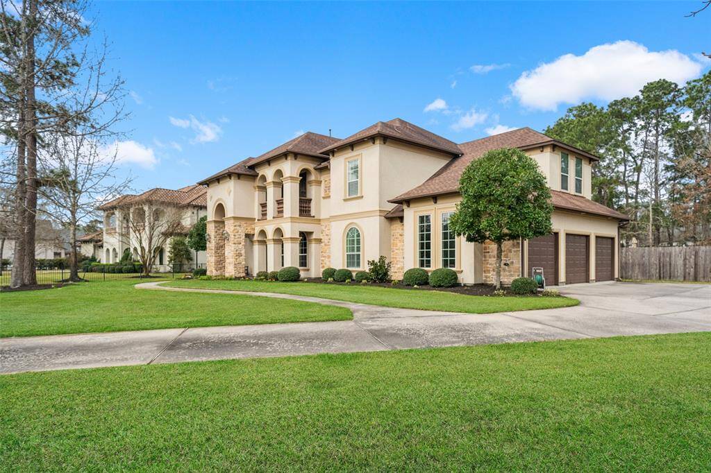 A side view of this beauty with 3 car garage.