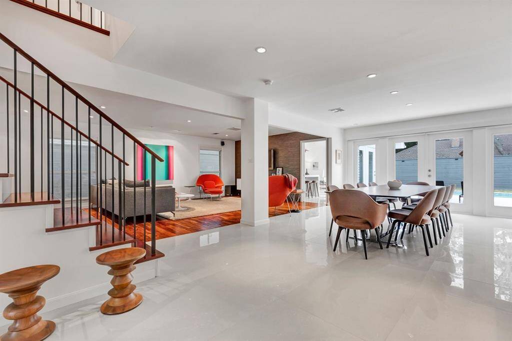 Exuding understated luxury, the home's modern, minimalist design seamlessly integrates living, dining, and entertaining spaces for an effortless flow. Unobstructed sight lines highlight architectural elegance, while warm wood tones and refined finishes showcase meticulous attention to detail throughout.