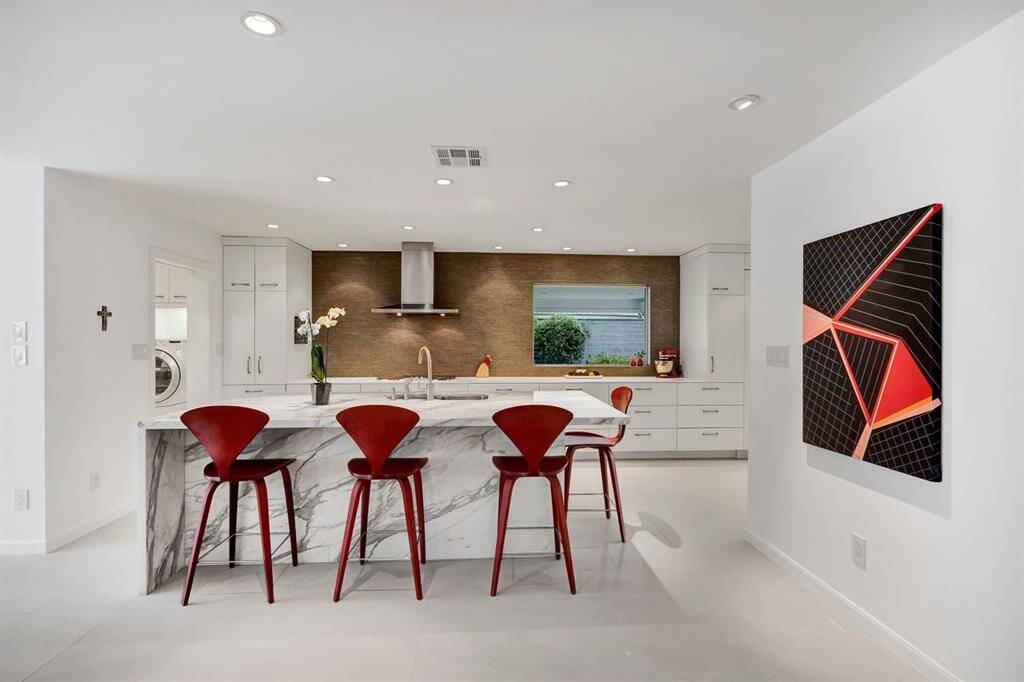 An undeniable statement of luxury and craftsmanship, the Calcutta Gold marble island is meticulously crafted from two rare slabs, expertly book-matched to highlight the stone’s dramatic veining. The single-slab top creates a seamless surface, enhancing the island’s sculptural presence while elevating the kitchen with timeless elegance.