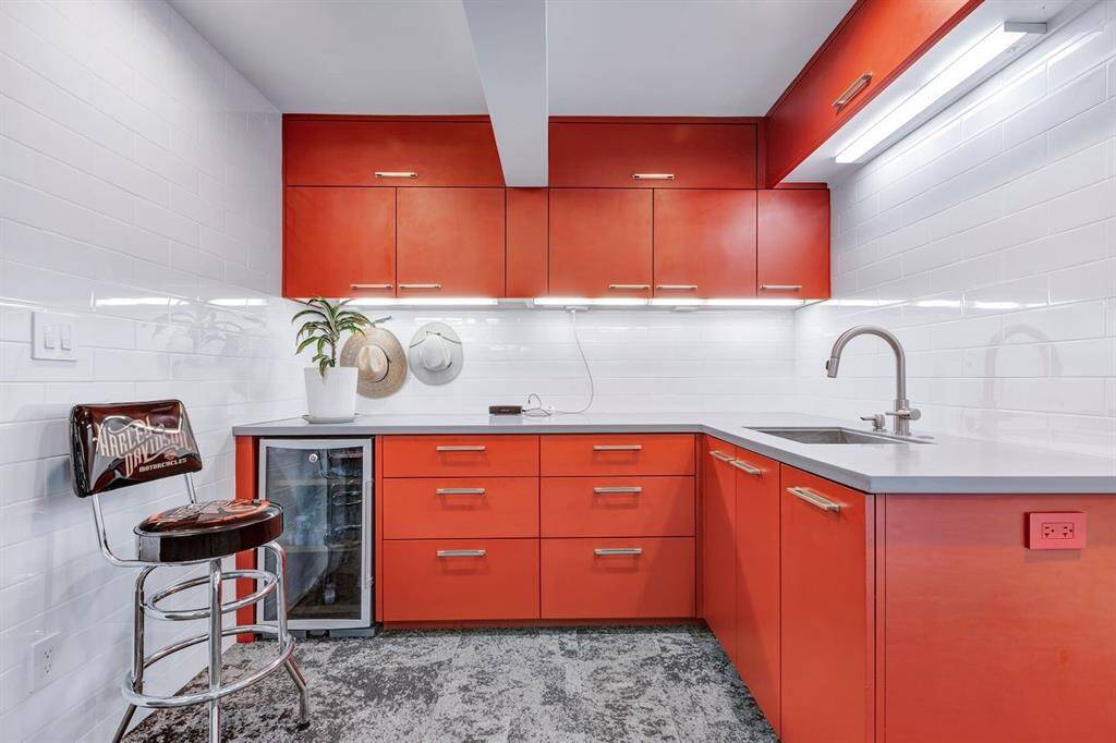 Enthusiastically designed for the organized homeowner, car aficionado, or hobbyist, this impeccably crafted garage blends high-end finishes with ultimate versatility. Bold custom cabinetry pairs with durable solid surface countertops and a refined subway tile backsplash for a polished aesthetic. Designed to accommodate multiple uses, this space effortlessly transforms from a fitness area to a fully functional garage with an automatic door opener, catering to both automotive enthusiasts and modern lifestyle.