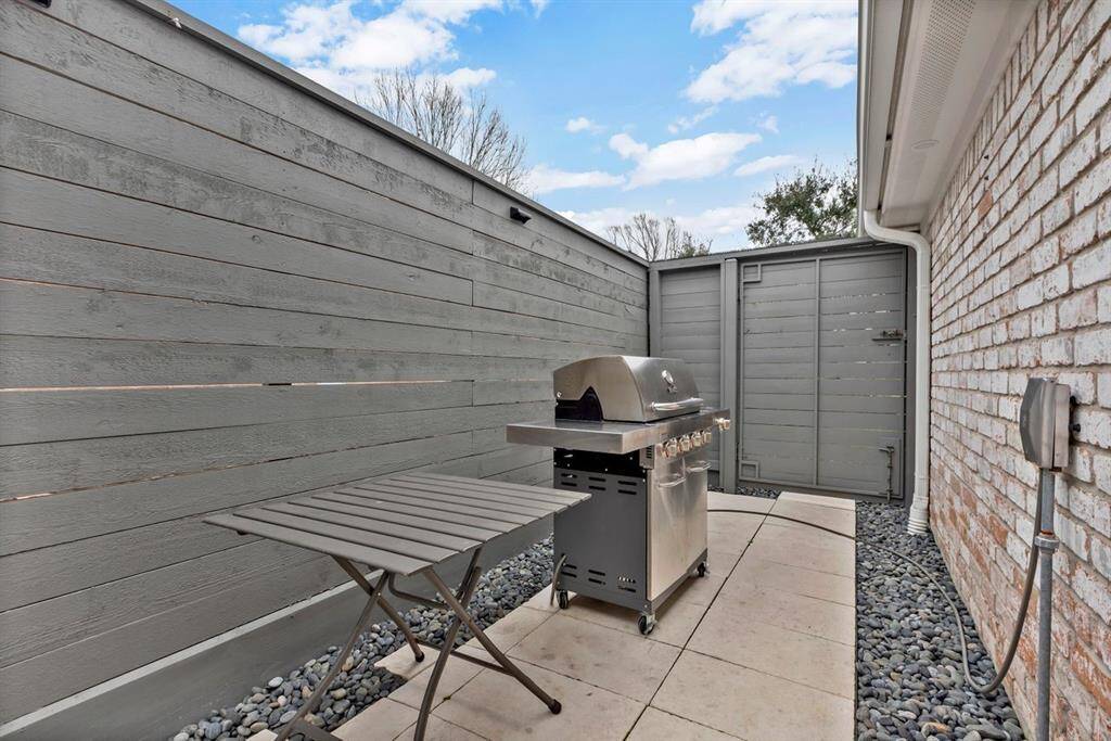 Located on the north side of the home, this private grilling area is easily accessible from the driveway, pool deck, or carport area. A limestone path walkway leads to a gas grill, which stays with the home and is conveniently connected to a dedicated gas line.