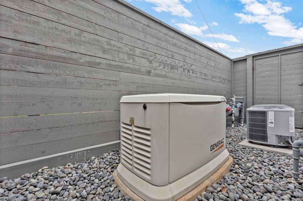 The 22kW Generac whole-house standby generator, utility connections, and pool equipment are strategically positioned in a discreet location behind the Pool House, ensuring easy access while maintaining the visual serenity of the outdoor space. Thoughtful placement, combined with the seamless design of the pool, deck, and surrounding features, enhances the luxurious feel of this outdoor retreat.