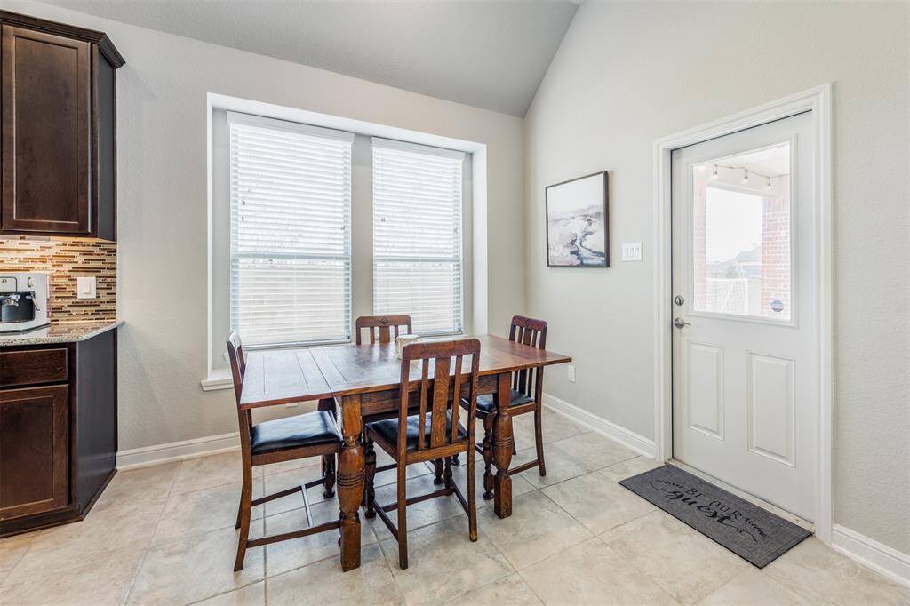 This cheerful breakfast room features windows to bring in lots of natural light! What a perfect place to start your day with a morning cup of coffee and breakfast!