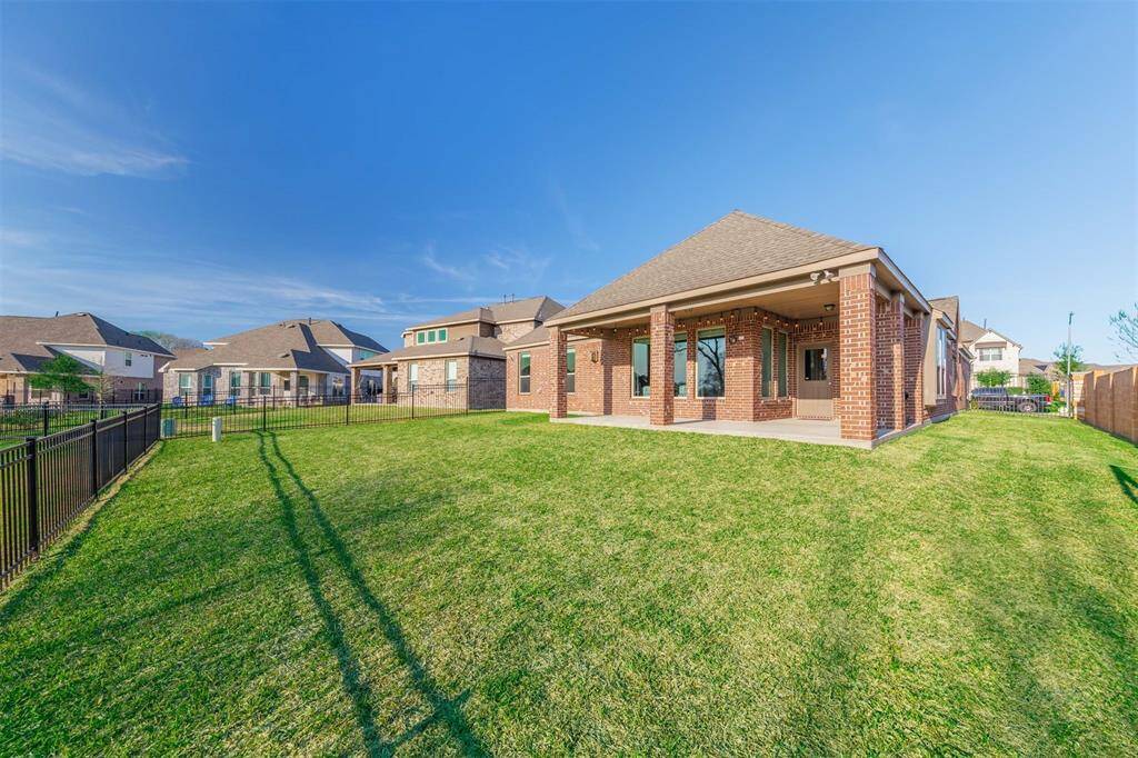 Step out back to the extended covered patio and enjoy the expansive, unobstructed view of the lush greenbelt behind the home. With no back neighbors, you can relax in privacy and take in the serene surroundings - perfect for outdoor entertaining or unwinding in the fresh air!