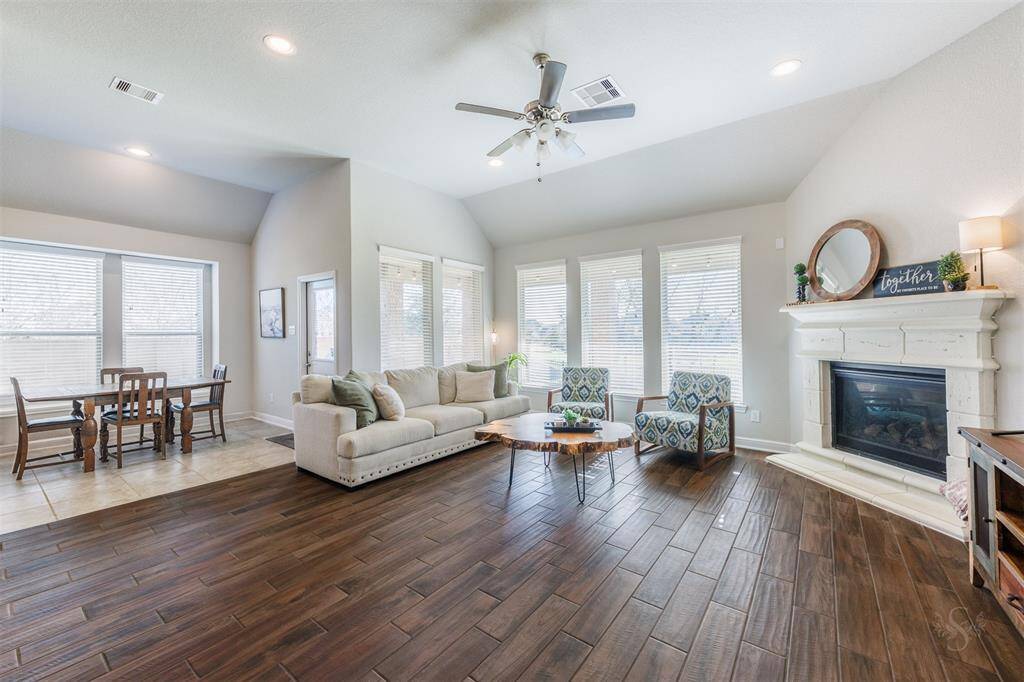 The light and bright family room provides a wall of windows letting in an abundance of natural light and showcases lovely open green space views! There's plenty of space for all the furniture you would like for your family and guests.