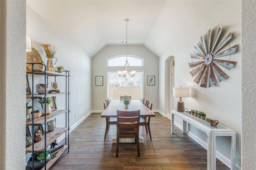 Enjoy having dinner parties in the formal dining room featuring wood-look tile flooring, high angled ceiling and plenty of room for a large dining table and china cabinet!