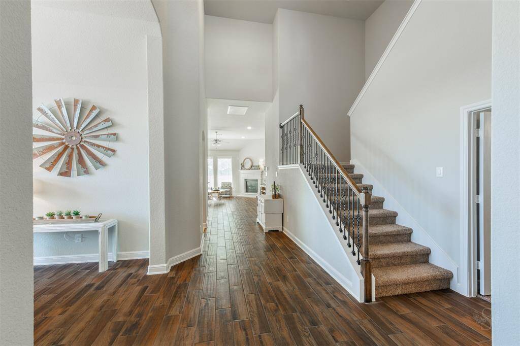 The front entry provides high ceilings with crown molding and leads to the formal dining room and split staircase  leading to 1 secondary bedroom & the game room!
