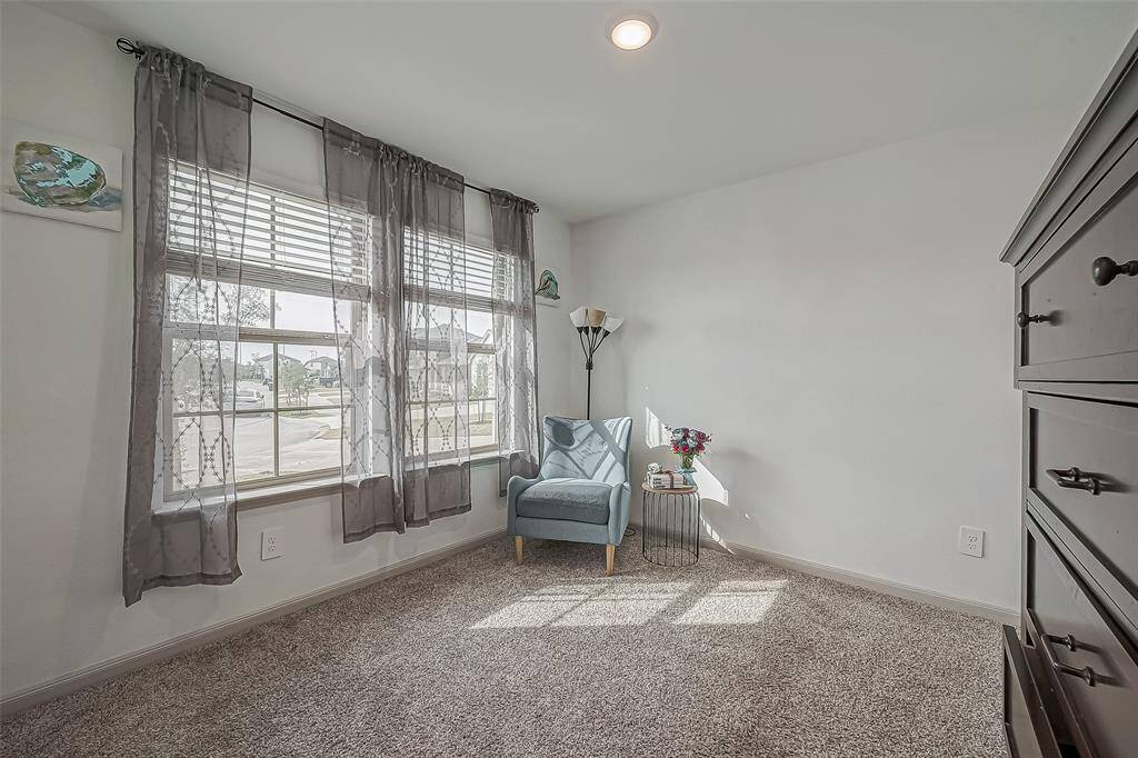 This cozy secondary bedroom features plenty of natural light and soft plush carpeting.