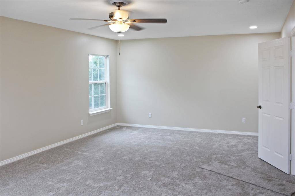 Upstairs primary bedroom featuring dual closets for storage.