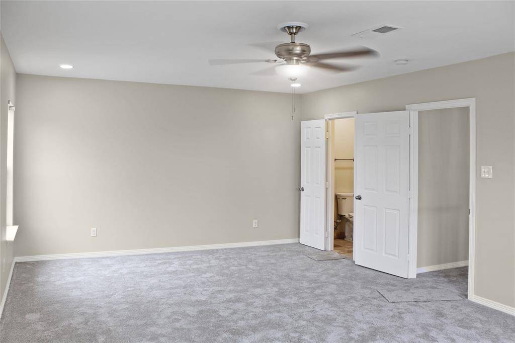 The second primary bedroom features a private bathroom with a shower and single sink.