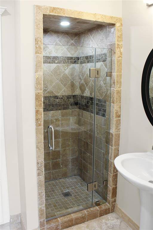 Luxurious ensuite bathroom with elegant tiled shower and modern fixtures.