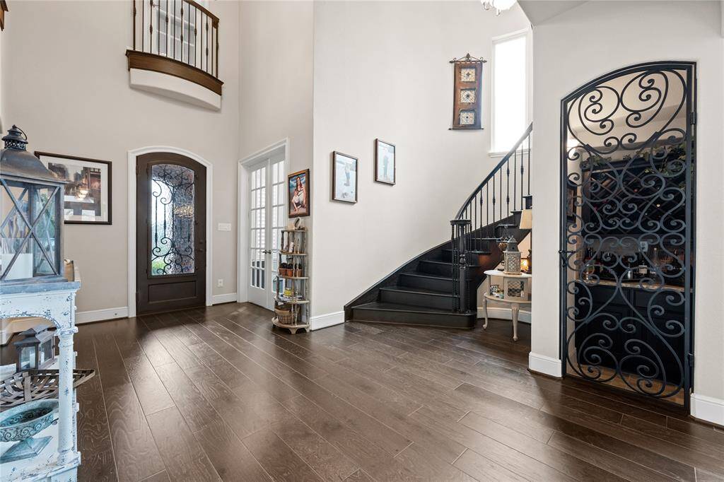 Dramatic entry! Engineered wood floors w/wrought iron stairway!