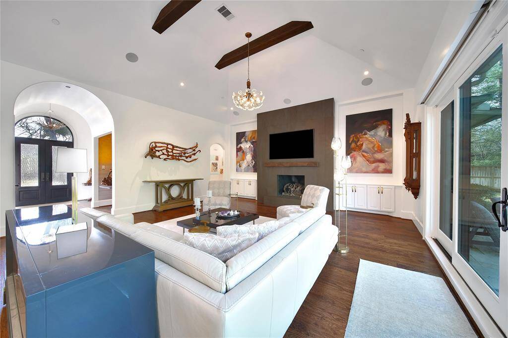 Stunning updated fireplace with porcelain surround finish and added reclaimed beam mantle.