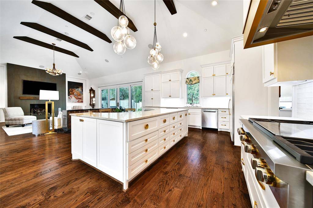 Beautifully updated kitchen with new cabinets, hardware, countertops, banquette breakfast area, hidden coffee bar, Wolfe Appliances, two dishwashers, updated sink and insta-hot faucet.
