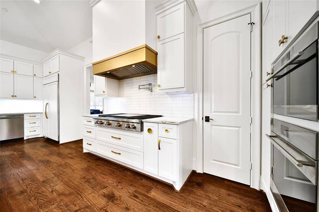 Beautifully updated kitchen with new cabinets, hardware, countertops, banquette breakfast area, hidden coffee bar, Wolfe Appliances, two dishwashers, updated sink and insta-hot faucet.