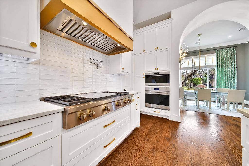 Beautifully updated kitchen with new cabinets, hardware, countertops, banquette breakfast area, hidden coffee bar, Wolfe Appliances, two dishwashers, updated sink and insta-hot faucet.